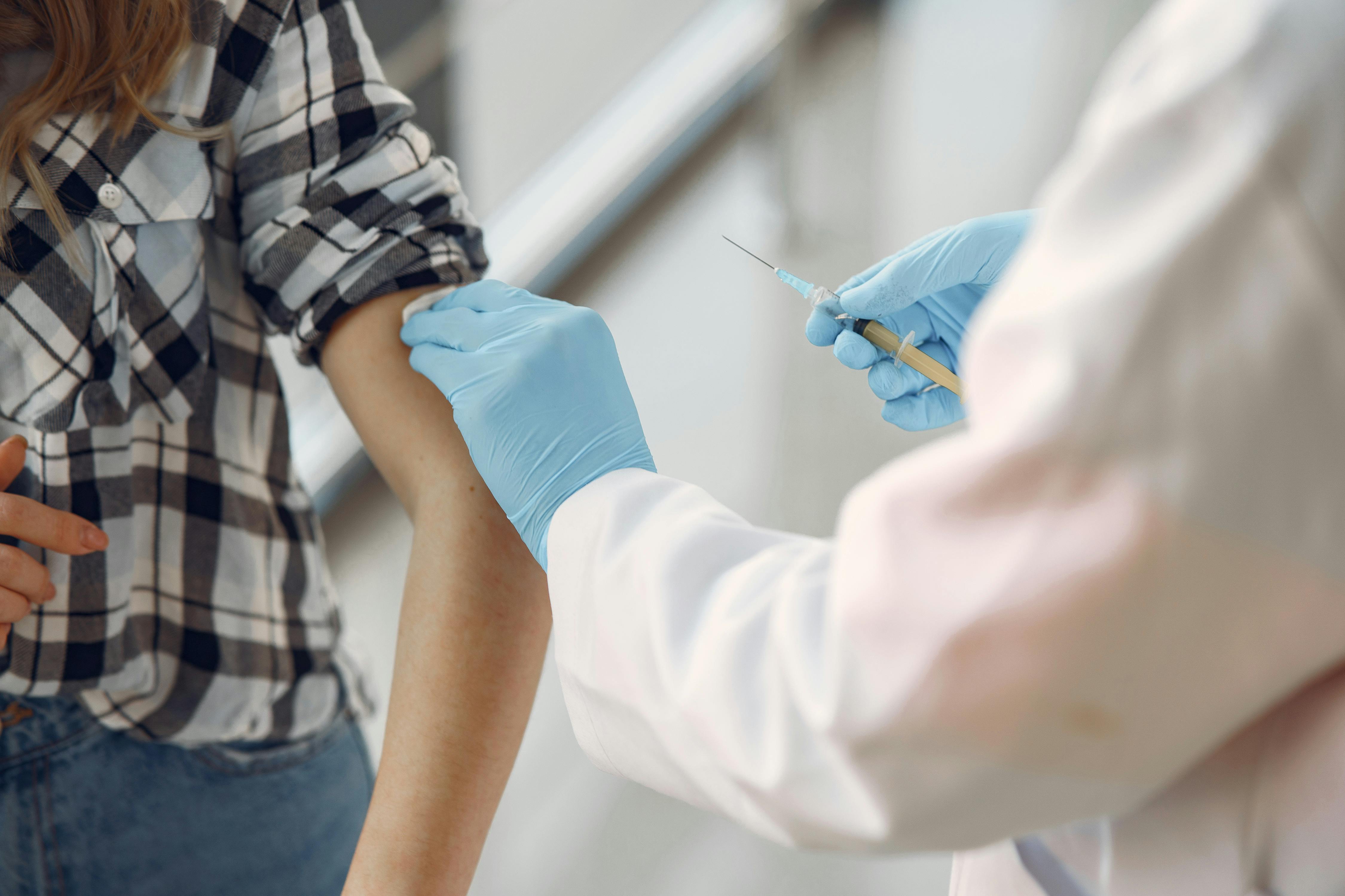 a Photo of a Person Getting Vaccinated by A Doctor