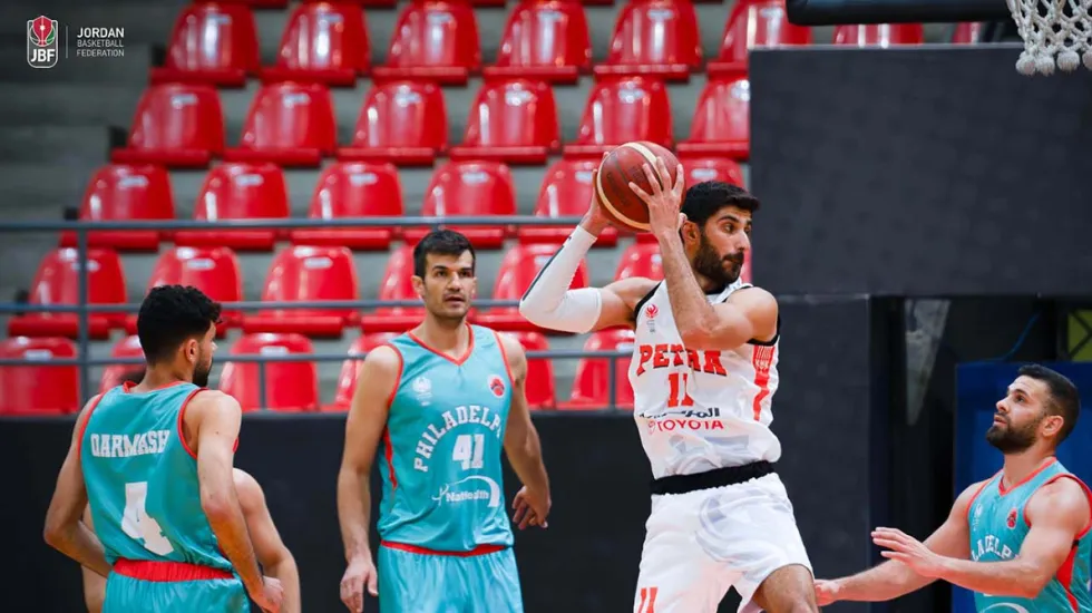 Basketball player avoiding three defenders