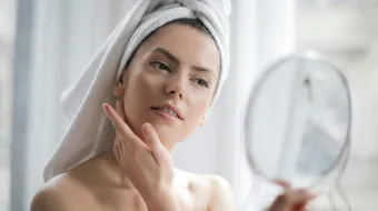 Woman With a Towel on Head Looking in the Mirror