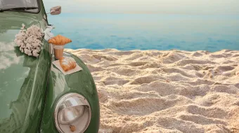Car on the beach with flowers on it, aesthetic